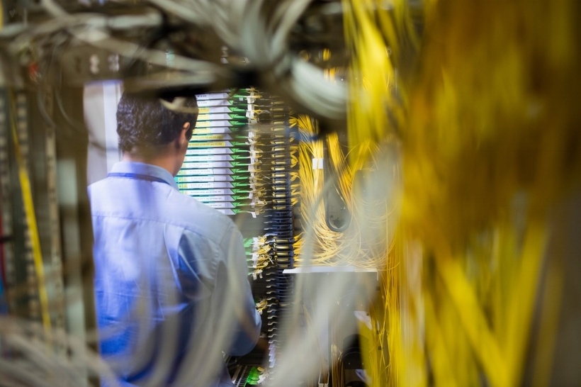 Close-up of technician checking routers in server room-494359-edited.jpeg