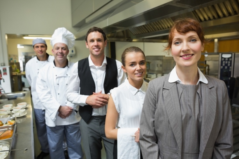 Nice female manager posing with the staff in a professional kitchen -995337-edited.jpeg